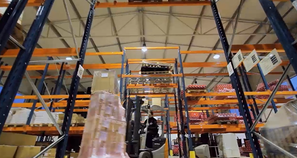 warehouse with worker operating the forklift